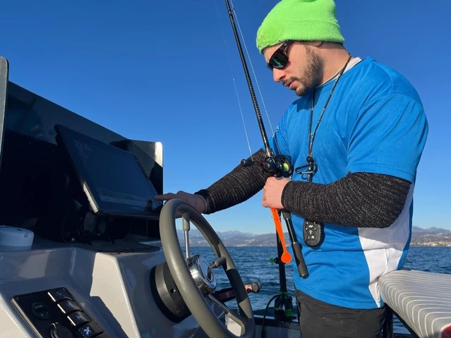 Fishing from a motorboat with a certified instructor on Lake Garda